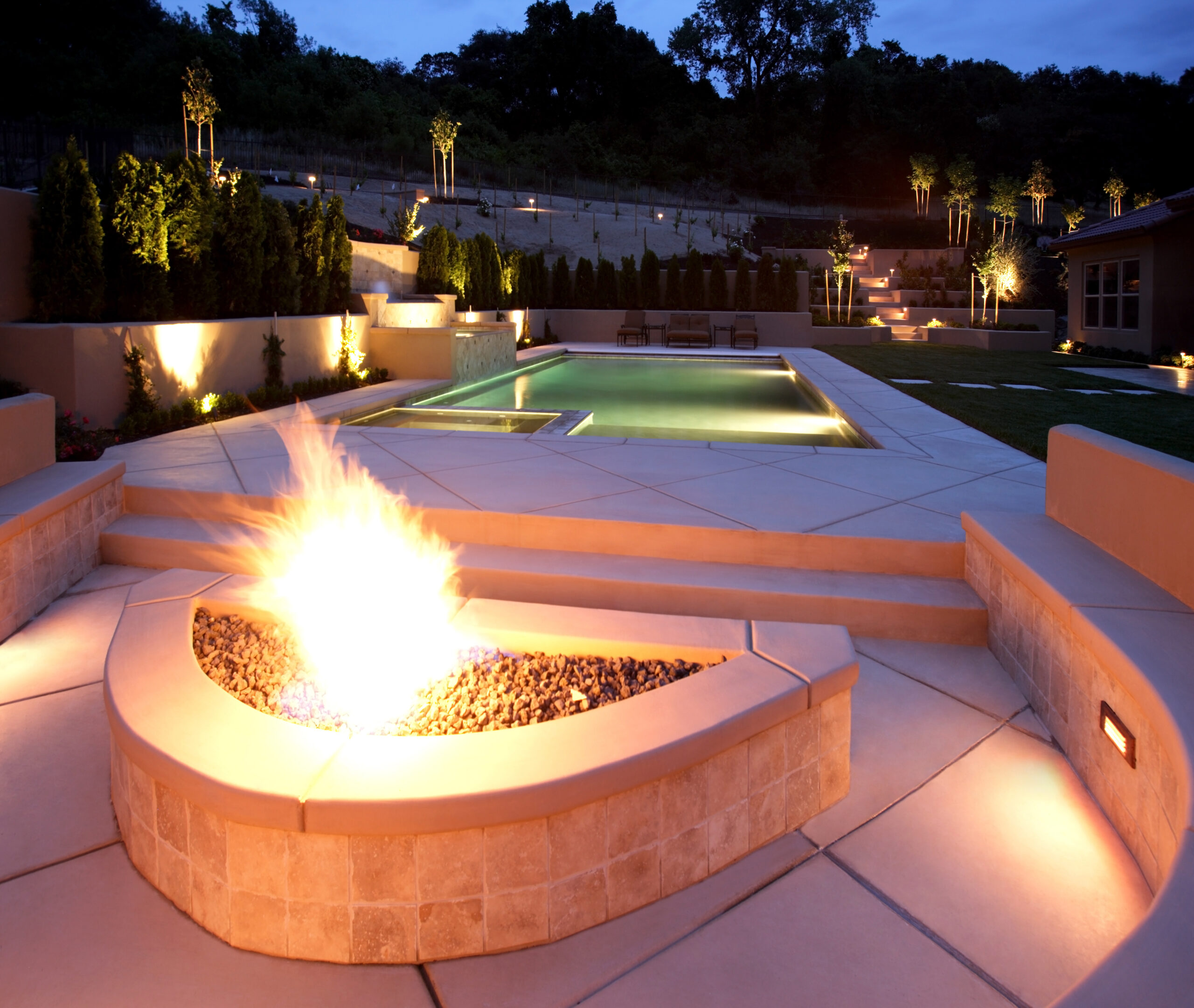 Featured image for “Creating a Nighttime Oasis: Integrating Firepits into Your Poolside Area”